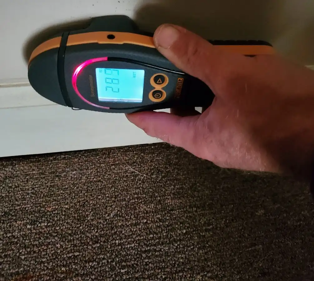 Moisture detection at baseboard during Storm Damage Restoration in Gilford
